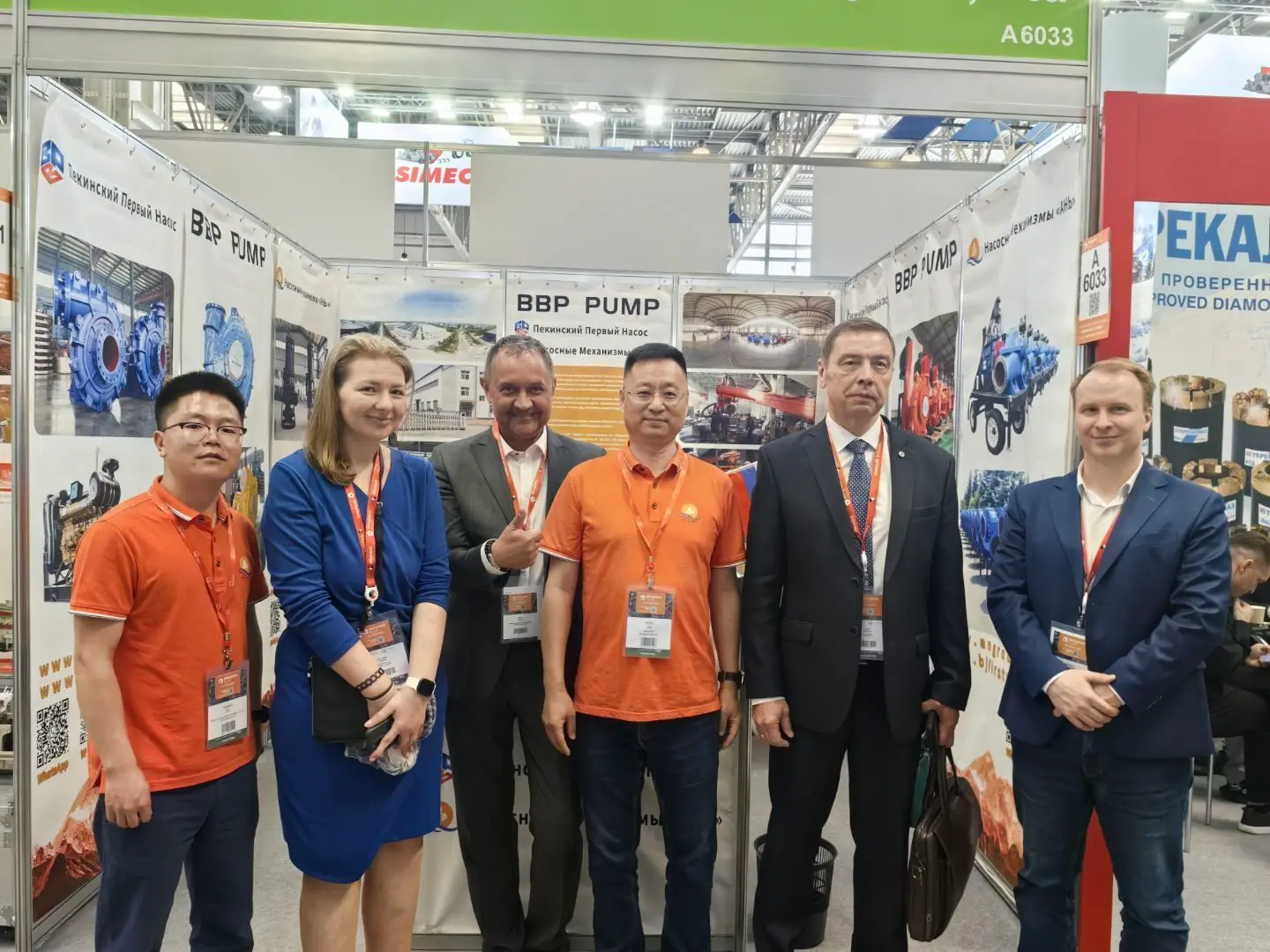Visitors and team members photographed at a BBP Pump exhibition stand