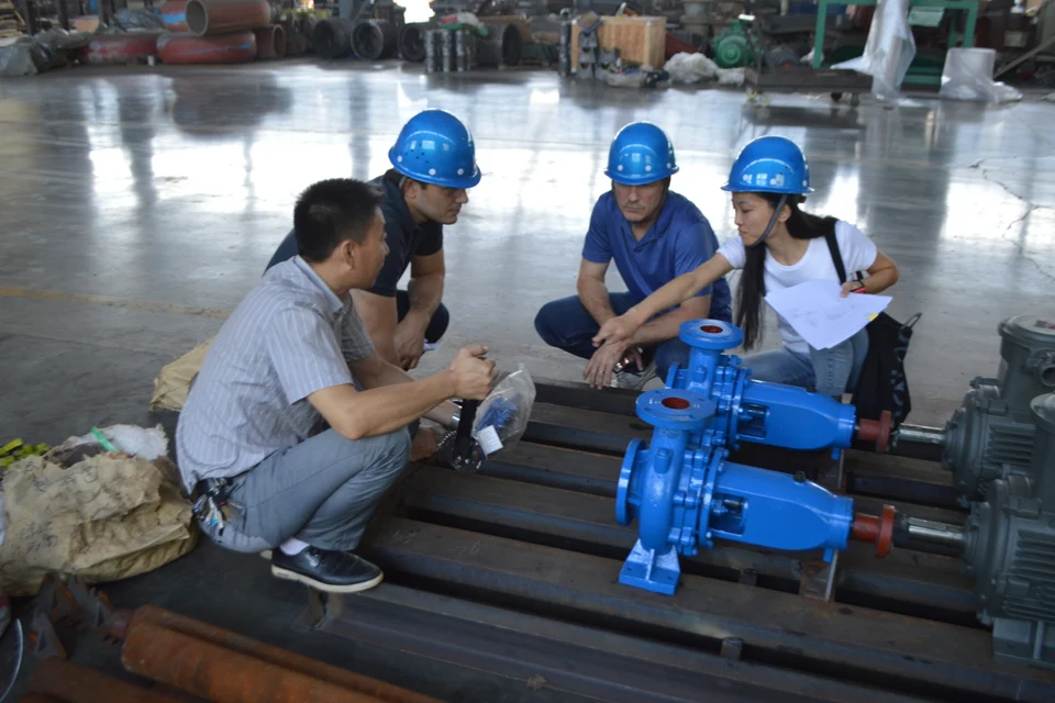 People discussing equipment in a workshop