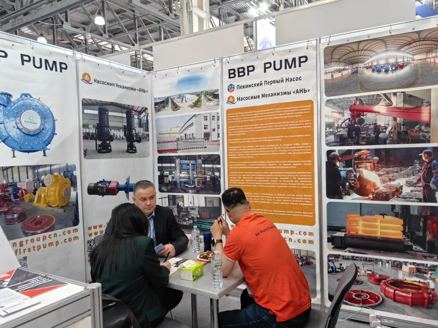 Discussion at an exhibition stand displaying BBP Pump materials