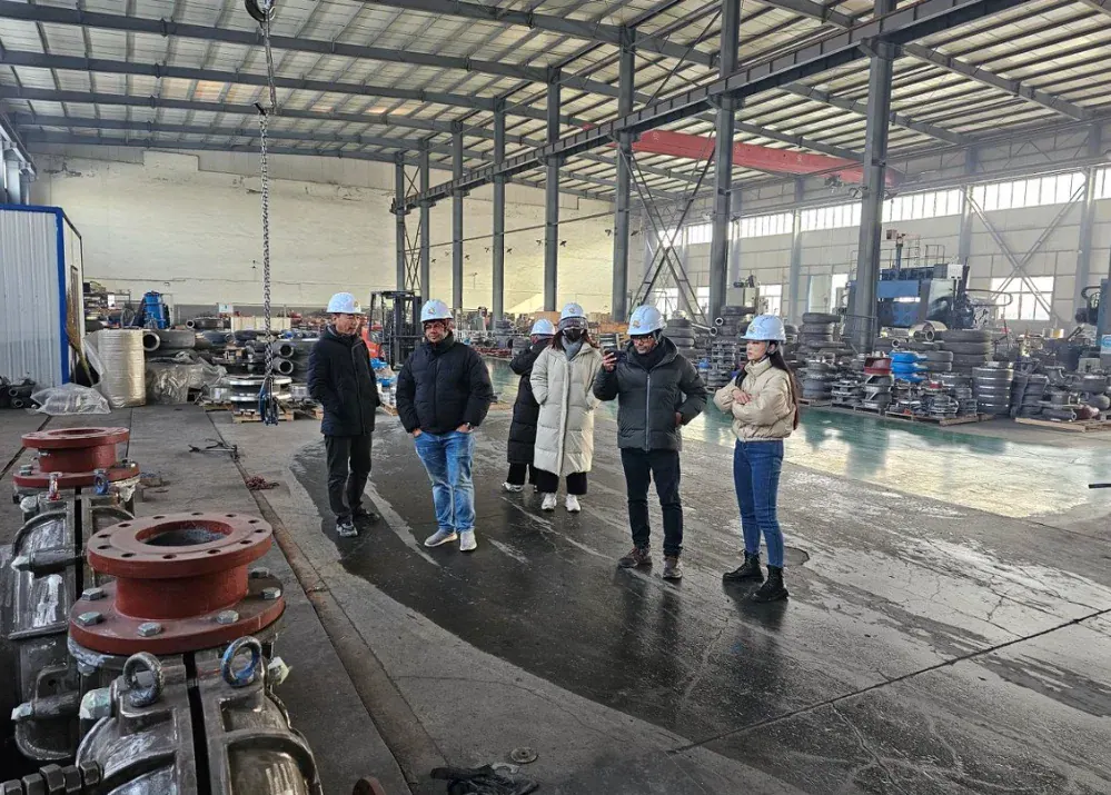A visiting group touring the pump workshop floor