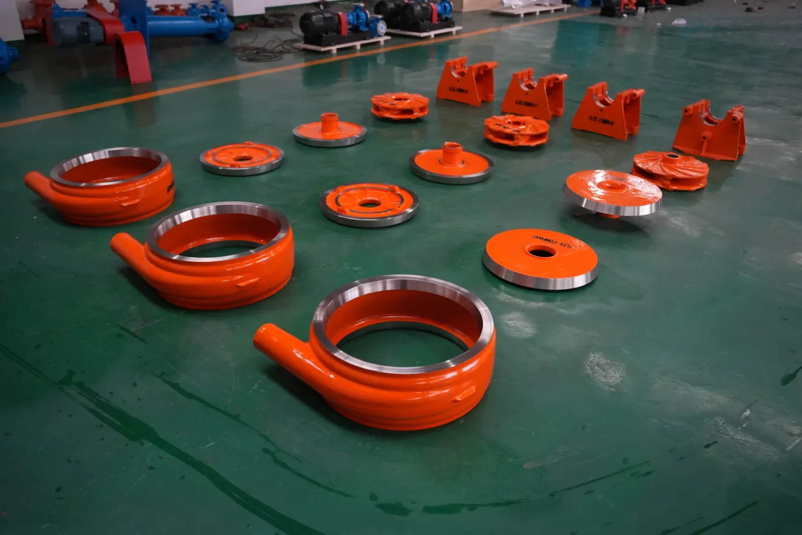Pump casings and impellers arranged on the workshop floor