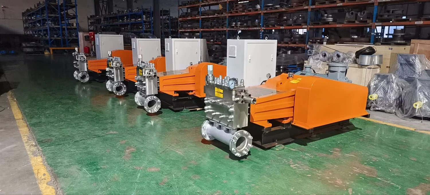 Workshop view of pump heads, control cabinets and skid assemblies